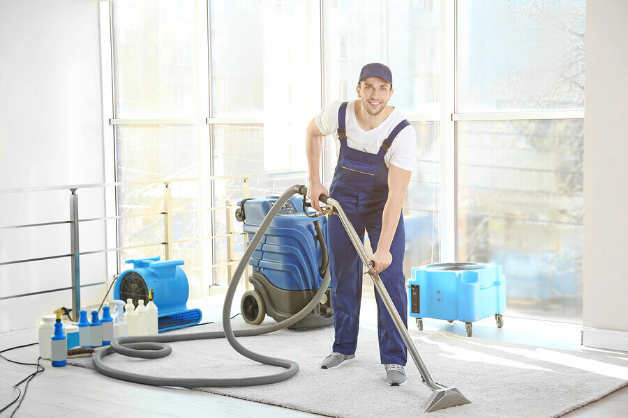 bigstock-Dry-cleaner-s-employee-removin-183173842-1